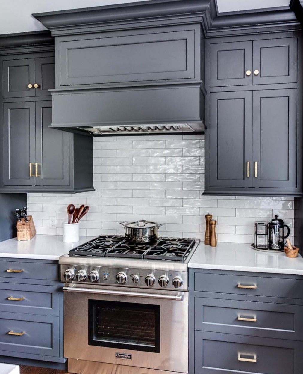 Cabinet color: wrought iron by Benjamin Moore Range and hood