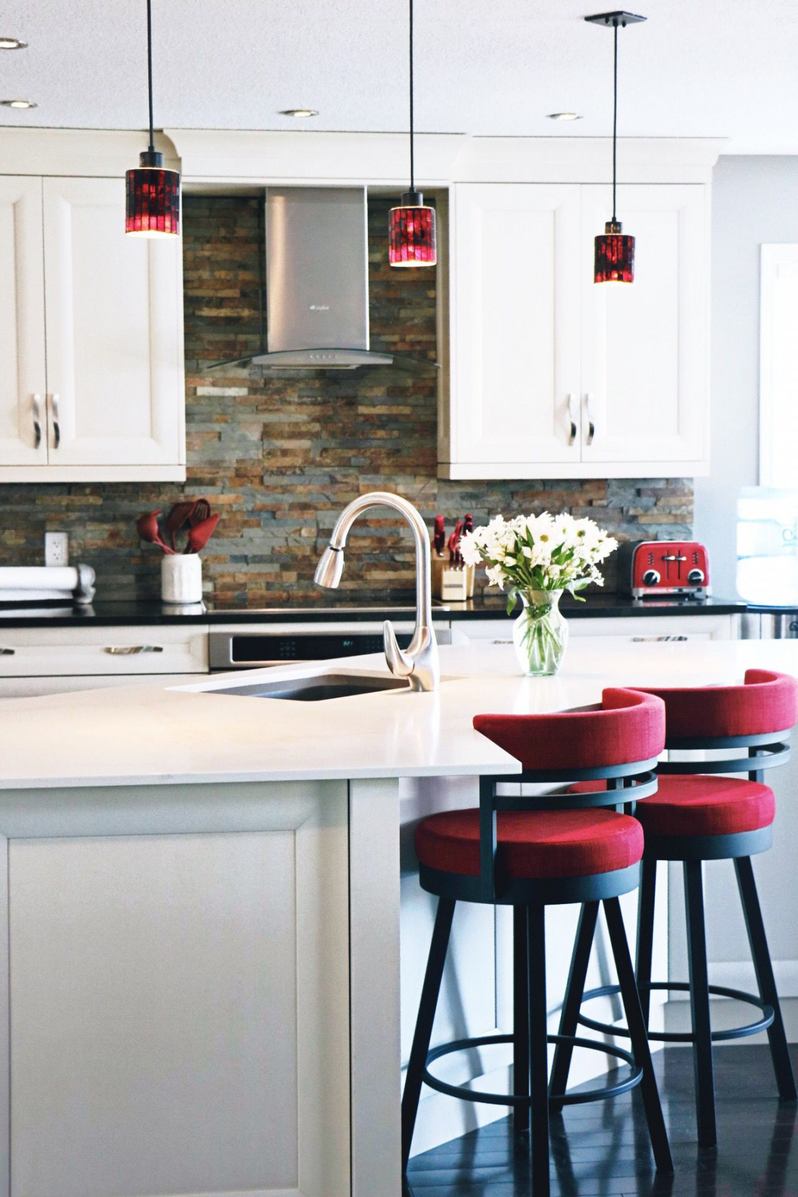 White kitchen, brick backsplash, red accents  Red kitchen decor