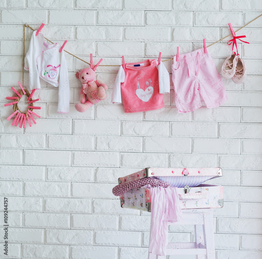 Baby clothes hanging on the wall as decoration of shooting