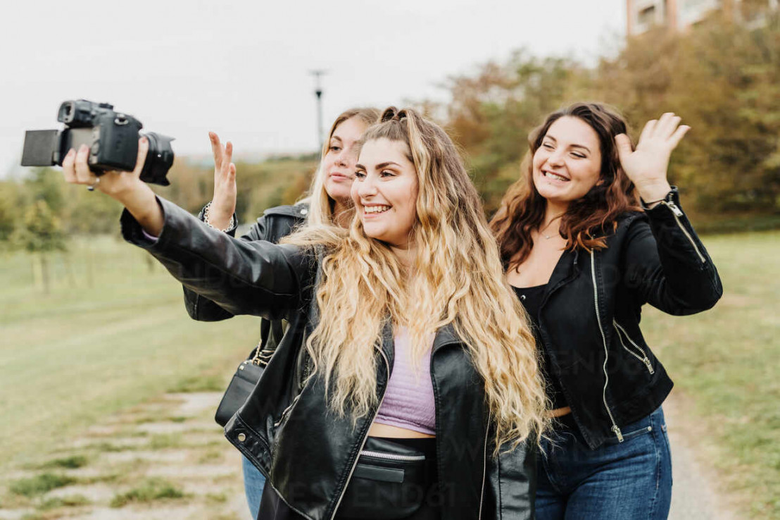 Friends taking selfie with camera stock photo