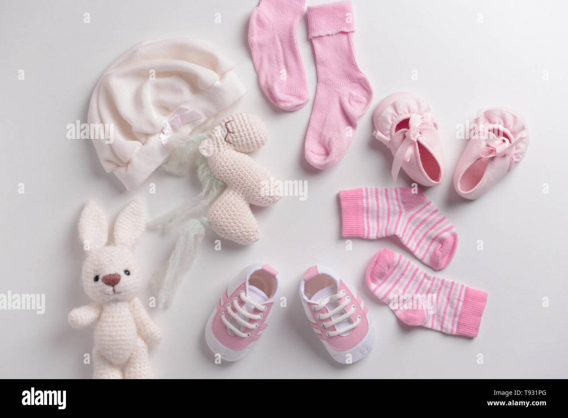 Baby clothes, shoes and toys on white background Stock Photo - Alamy